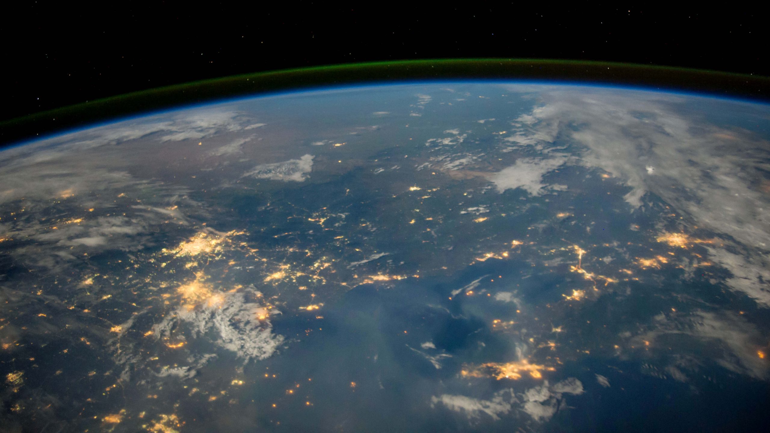a view of the earth with cities illuminated
